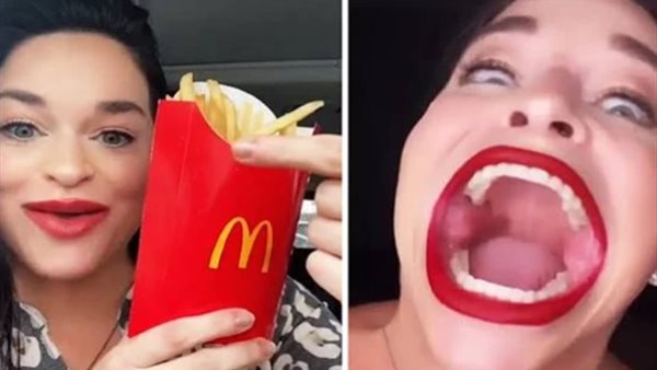 التهام ساندوتش وعلبة بطاطس دفعة واحدة.. صاحبة أكبر فم في العالم تتحدى|شاهد