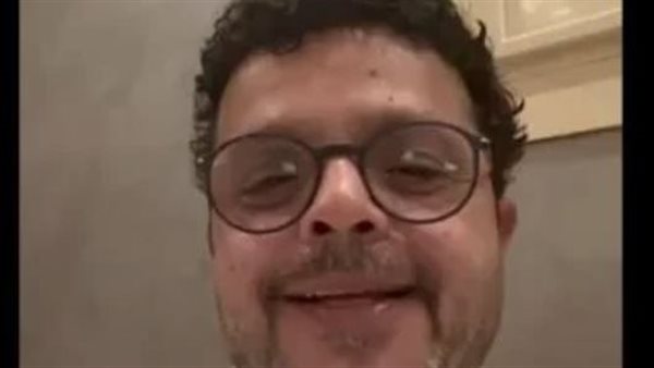 شعر كنيش ولحية غريبة.. صورة لمحمد هنيدي من المستشفى تكشف تفاصيل حالته الصحية | شاهد